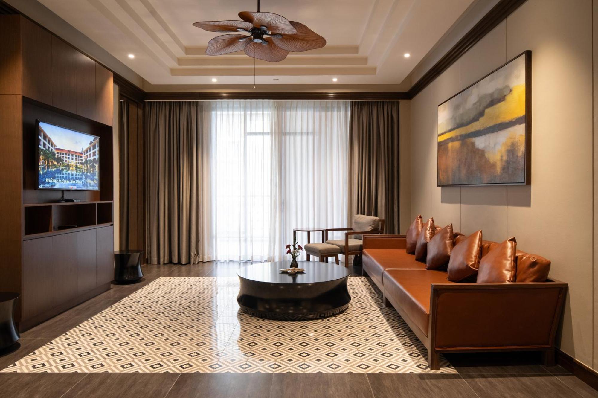 Senna Hue Hotel Exterior foto A living room with a ceiling fan